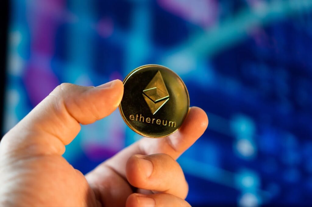Hand holding an Ethereum coin