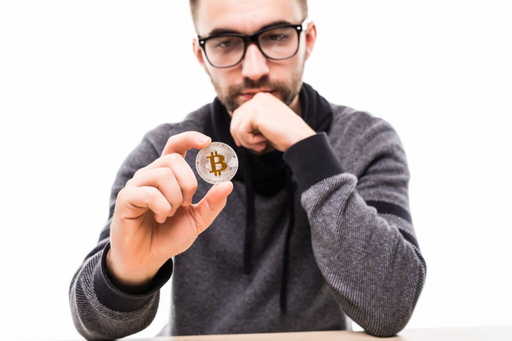 Young man thinking over bitcoin