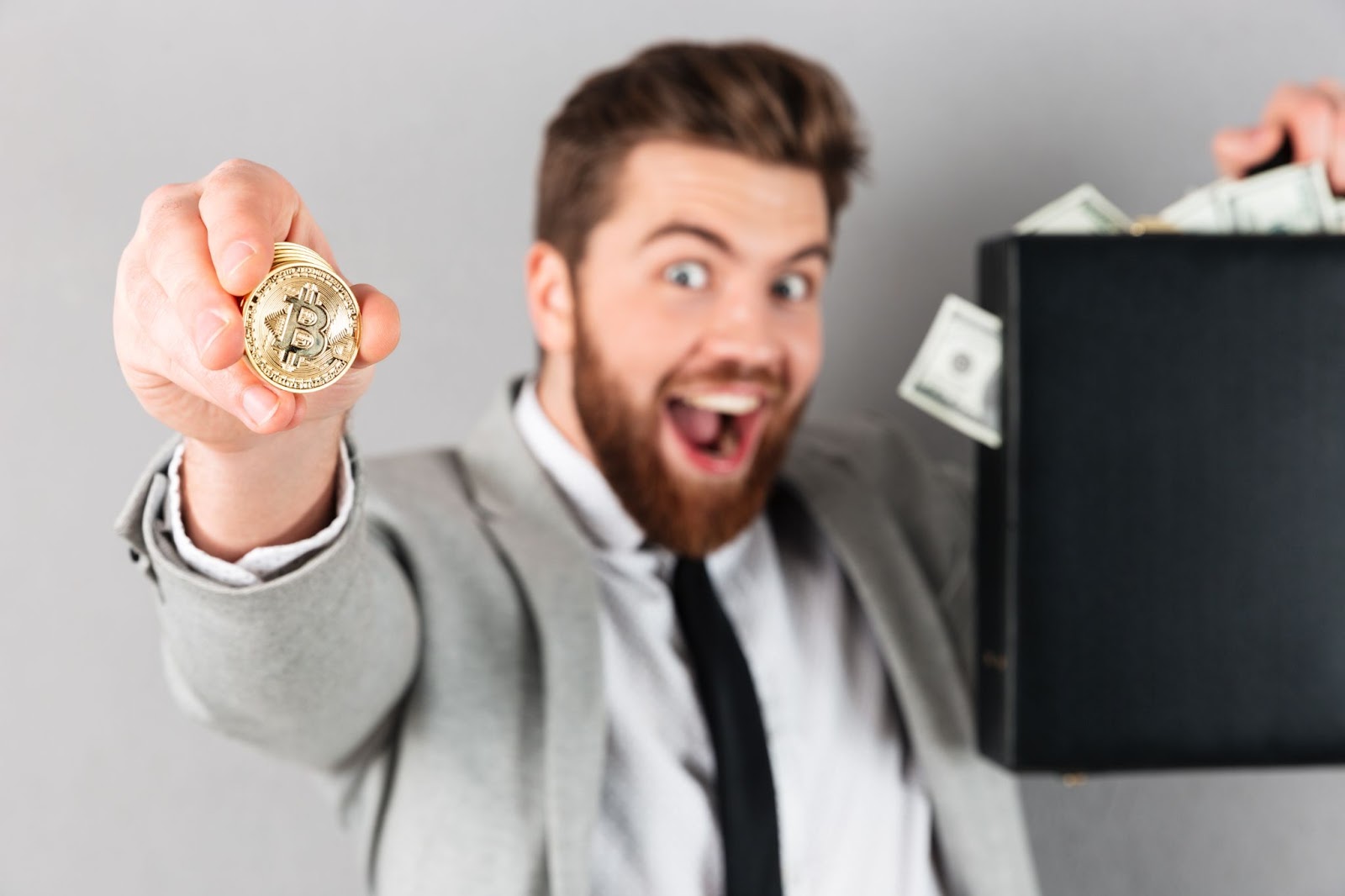 Happy man showing golden bitcoin